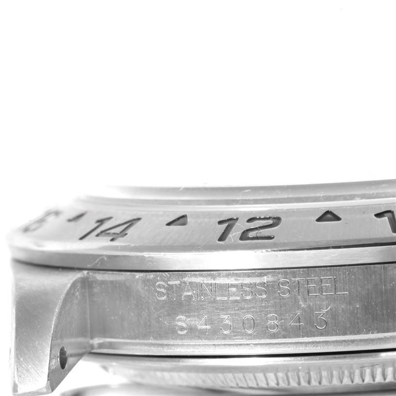 This close-up image shows the stainless steel bezel and edge of the casing of a Rolex Explorer 16570 Men
s Stainless Steel White Dial 16570 Men
s Stainless Steel White Dial watch.