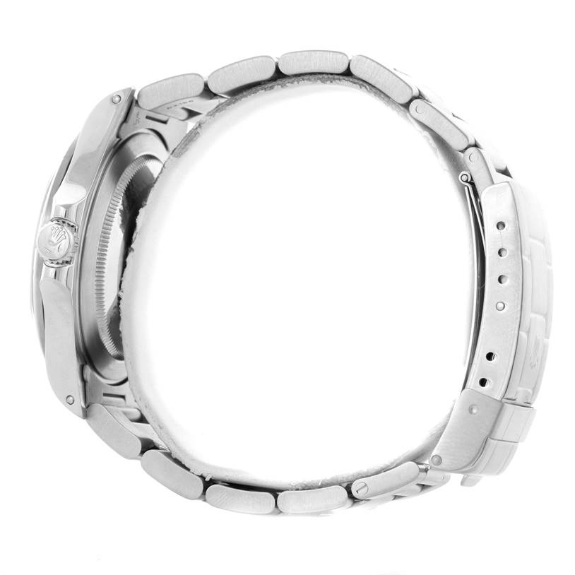 The image shows a side view of a Rolex Explorer 16570 Men
s Stainless Steel White Dial 16570 Men
s Stainless Steel White Dial watch, highlighting its case, bracelet, clasp, and crown.