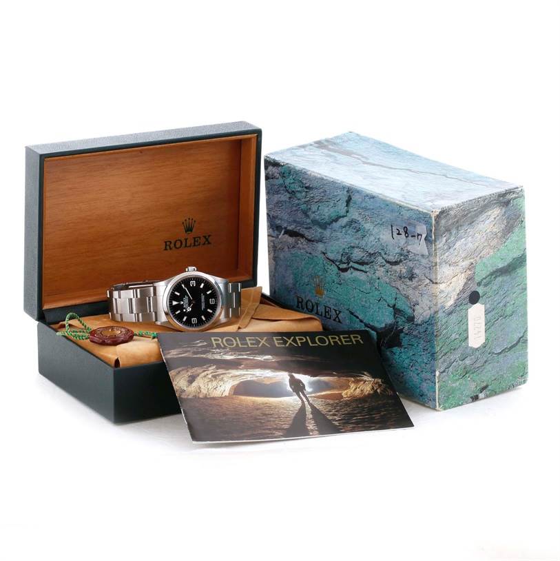 This image shows a Rolex Explorer 14270 Men's Stainless Steel Black Dial 14270 Men's Stainless Steel Black Dial watch with its packaging, including the inner and outer boxes, a booklet, and a tag.