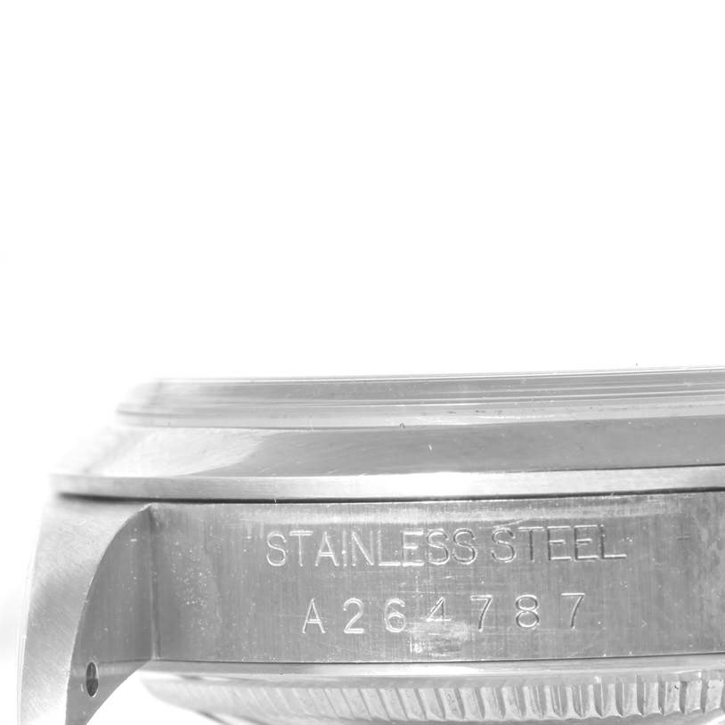 The image shows a close-up side view of a Rolex Explorer 14270 Men's Stainless Steel Black Dial 14270 Men's Stainless Steel Black Dial watch case, displaying "STAINLESS STEEL" and the serial number.