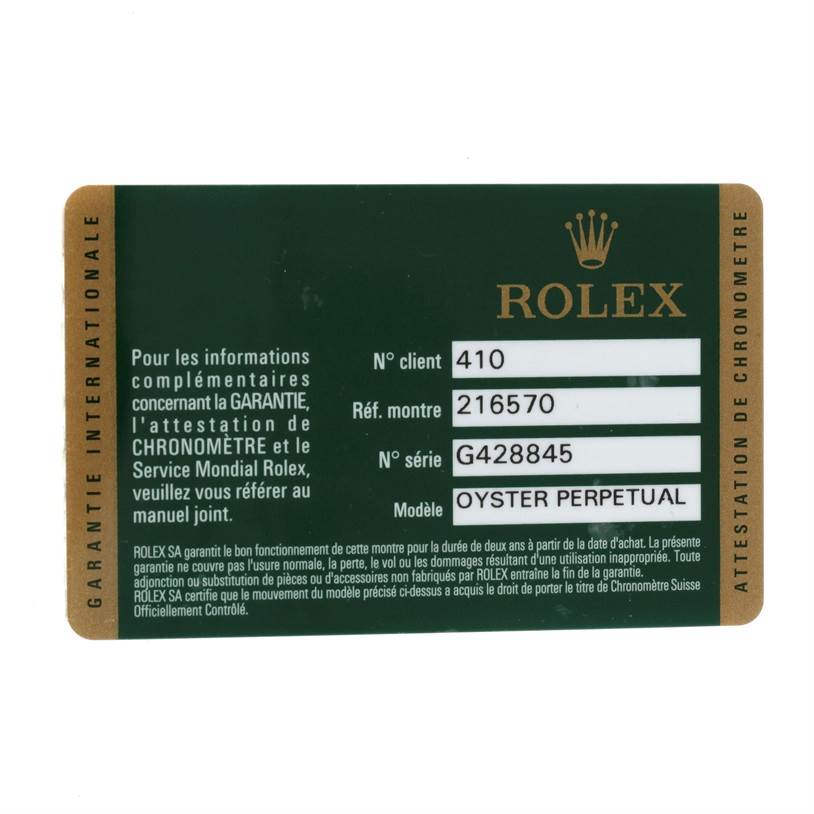 The image shows a Rolex warranty card for the Rolex Explorer 216570 Men's Stainless Steel White Dial 216570 Men's Stainless Steel White Dial model from an overhead angle.