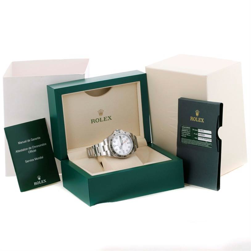 This image shows a Rolex Explorer 216570 Men's Stainless Steel White Dial 216570 Men's Stainless Steel White Dial watch from a front angle, in its open box, alongside manuals and warranty card.