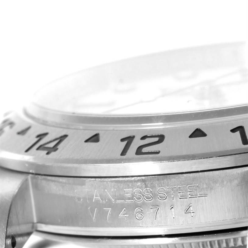 The image shows a close-up side view of the bezel and case of a stainless steel Rolex Explorer 16570 Men
s Stainless Steel White Dial 16570 Men
s Stainless Steel White Dial watch, highlighting the engraved numbers and serial number.