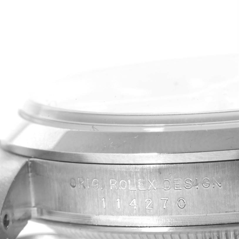 This image shows a side angle of a Rolex Explorer 114270 Men's Stainless Steel Black Dial 114270 Men's Stainless Steel Black Dial model, featuring the case and bezel with the model number 114270 engraved.