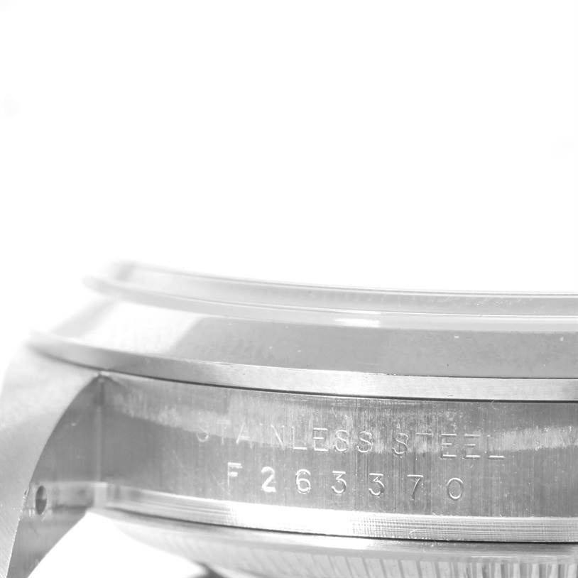 The image shows a close-up side angle of the stainless steel case of a Rolex Explorer 114270 Men's Stainless Steel Black Dial 114270 Men's Stainless Steel Black Dial watch, highlighting the serial number.