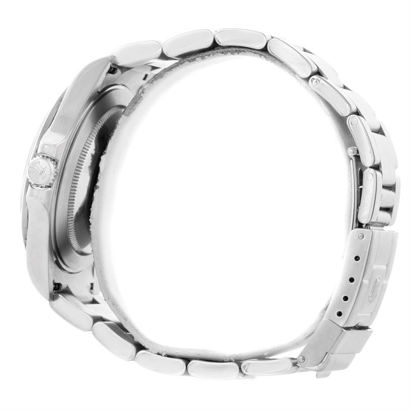 The image shows a side view of a Rolex Explorer 16570 Men's Stainless Steel White Dial 16570 Men's Stainless Steel White Dial watch displaying its case, crown, and metal bracelet with clasp.