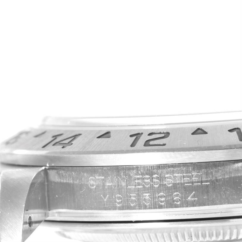 This close-up of a Rolex Explorer 16570 Men's Stainless Steel White Dial 16570 Men's Stainless Steel White Dial model shows the side view of the bezel and the engraved serial number on the case.