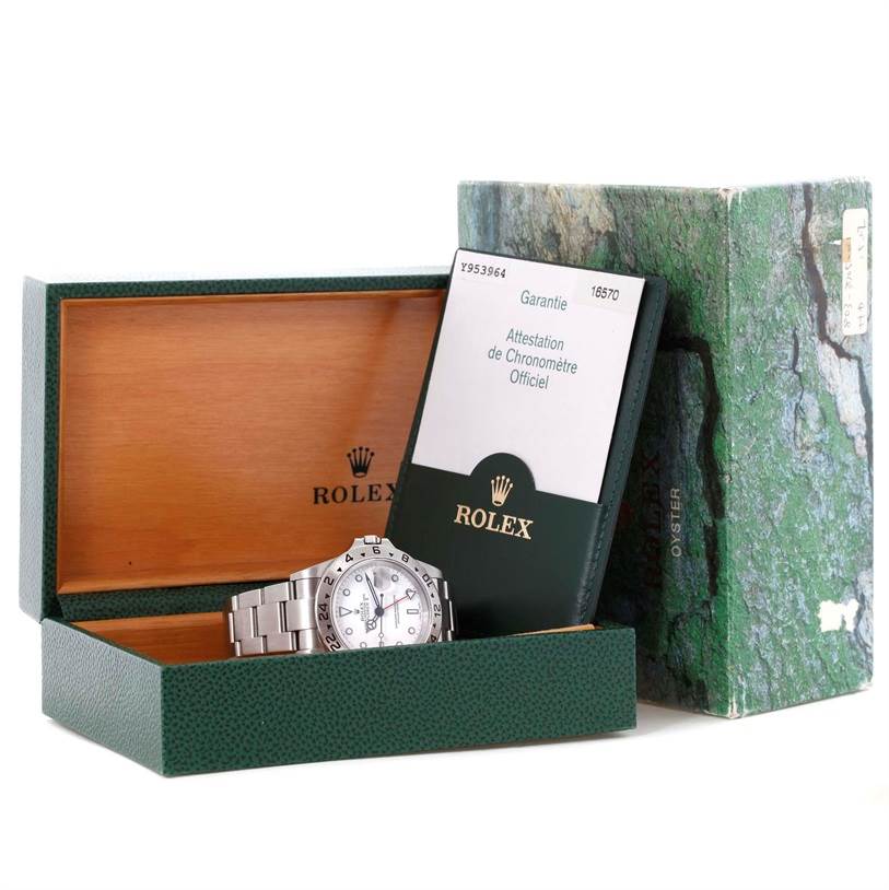 The image shows a Rolex Explorer 16570 Men's Stainless Steel White Dial 16570 Men's Stainless Steel White Dial watch inside its open box, along with a warranty card and outer packaging.