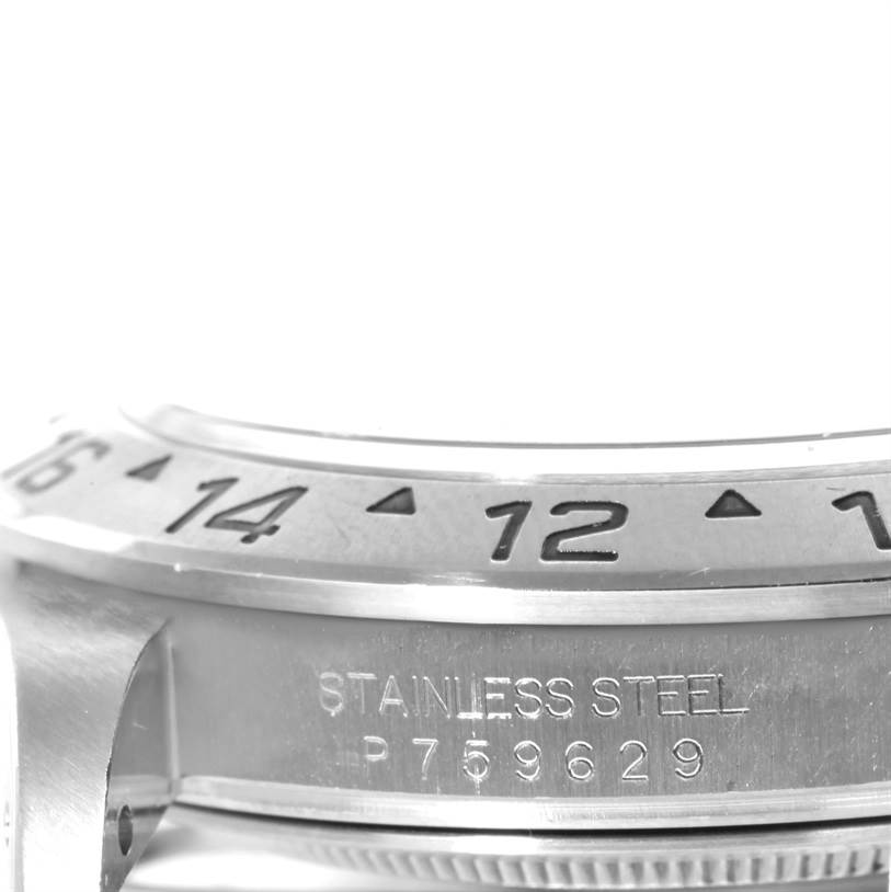 This close-up image shows the stainless steel casing and part of the bezel of a Rolex Explorer 16570 Men's Stainless Steel White Dial 16570 Men's Stainless Steel White Dial watch.