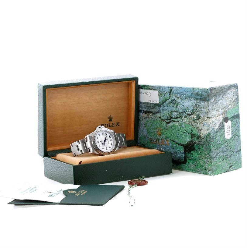 The image shows a Rolex Explorer 16570 Men's Stainless Steel White Dial 16570 Men's Stainless Steel White Dial watch inside an open box, with accompanying manuals and hang tags visible.