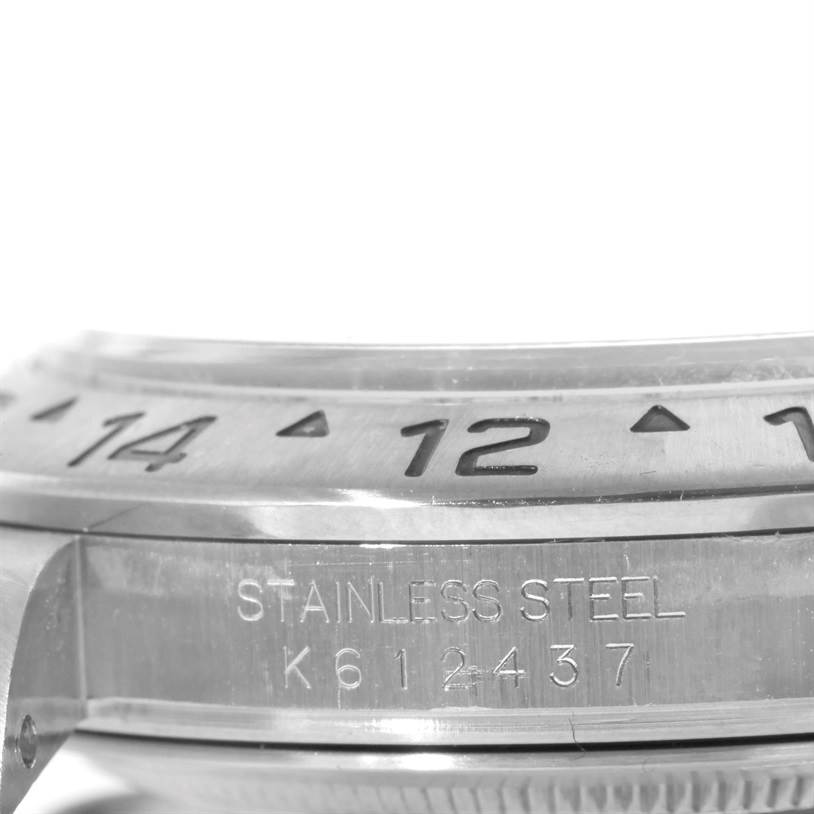 This close-up image shows the bezel and part of the casing of a Rolex Explorer 16570 Men's Stainless Steel White Dial 16570 Men's Stainless Steel White Dial watch, highlighting the engraved numbers and stainless steel construction.