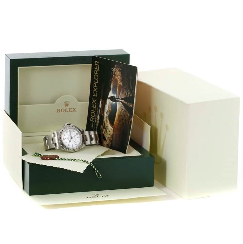 The image shows a Rolex Explorer 16570 Men's Stainless Steel White Dial 16570 Men's Stainless Steel White Dial watch inside its open box, along with its booklet and tags.
