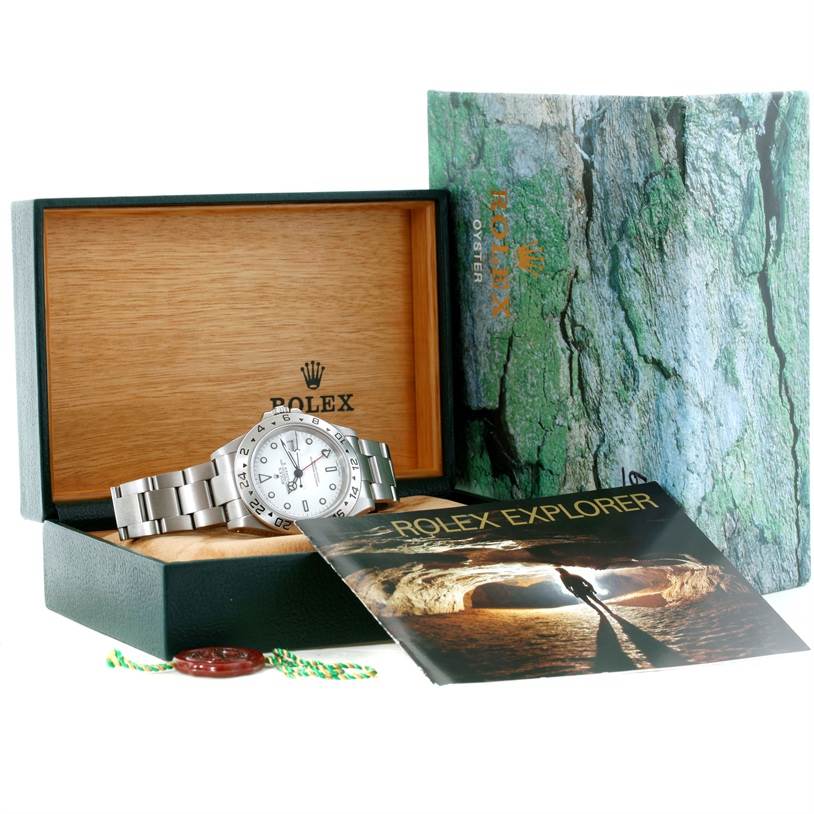The Rolex Explorer 16570 Men's Stainless Steel White Dial 16570 Men's Stainless Steel White Dial watch is displayed in its open box with a booklet and accessories included.