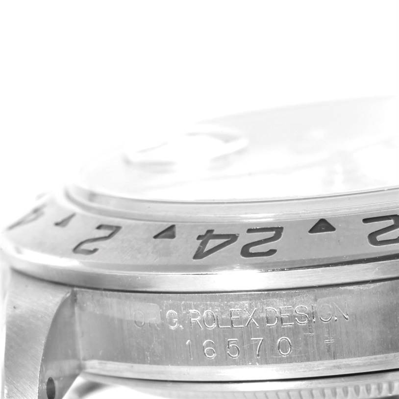 The image shows a close-up side view of the bezel and case of a Rolex Explorer 16570 Men's Stainless Steel White Dial 16570 Men's Stainless Steel White Dial model, with "ORIG ROLEX DESIGN" and "16570" engraved.