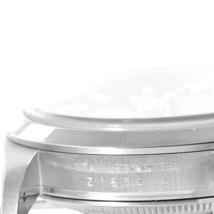 The image shows a side view of a Rolex Explorer 114270 Men's Stainless Steel Black Dial 114270 Men's Stainless Steel Black Dial watch case with the text "STAINLESS STEEL" and a serial number.