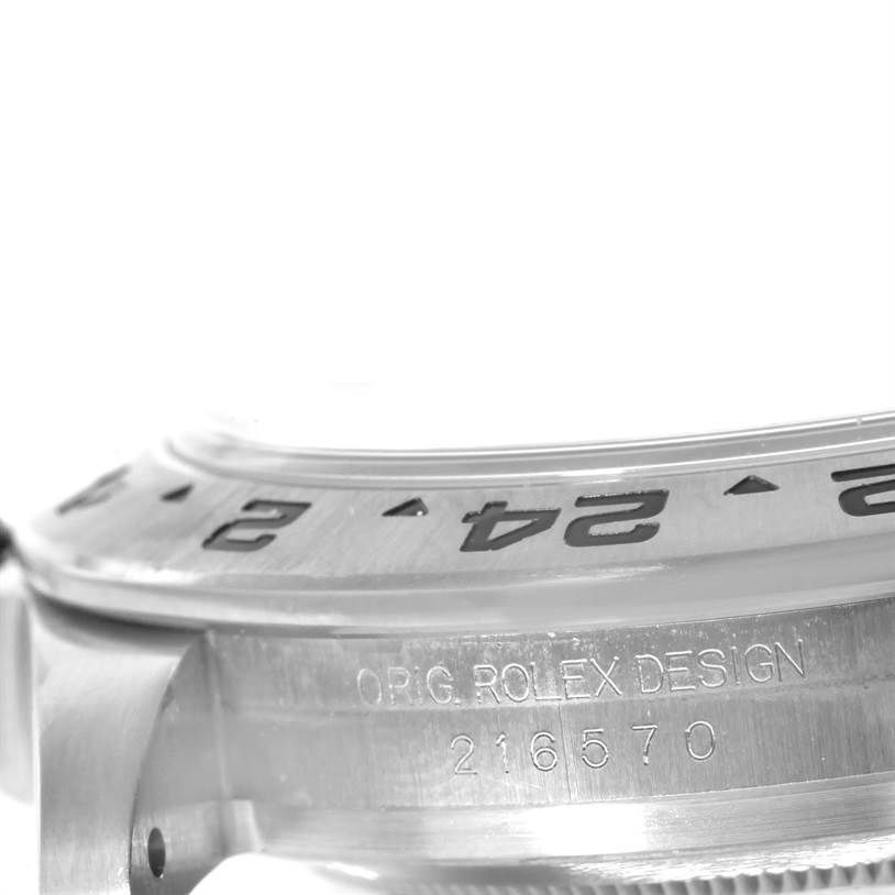 This image shows a close-up side view of the bezel and engraved case of the Rolex Explorer 216570 Men's Stainless Steel White Dial 216570 Men's Stainless Steel White Dial watch, model number 216570.