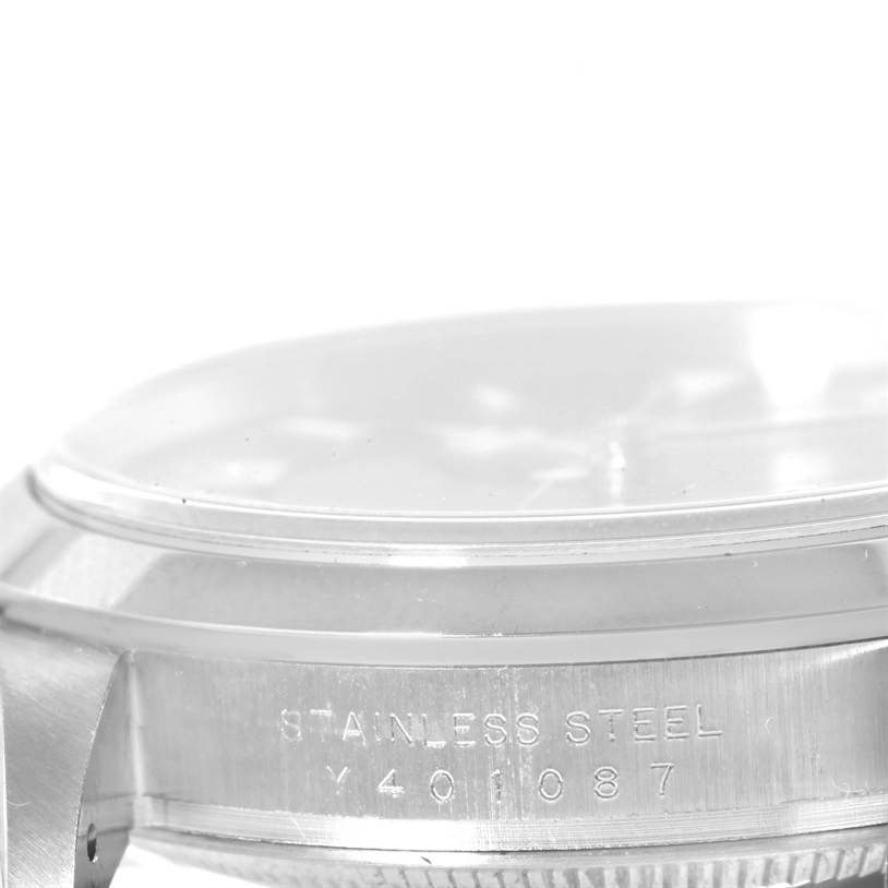 The image shows a side view of the Rolex Explorer 114270 Men's Stainless Steel Black Dial 114270 Men's Stainless Steel Black Dial watch, highlighting the stainless steel case and serial number.