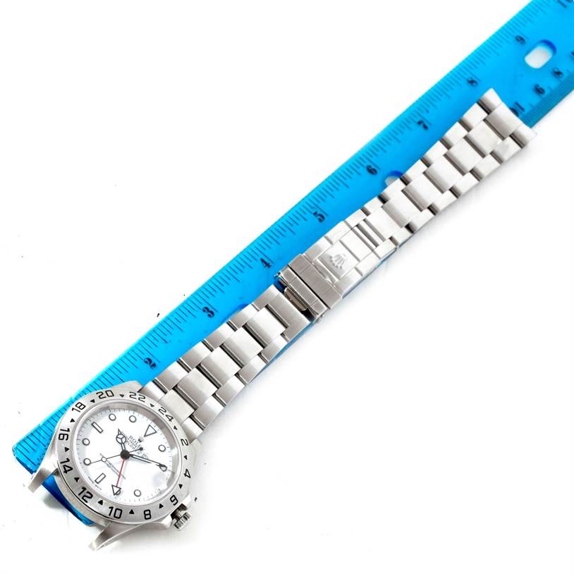 The image shows a stainless steel Rolex Explorer 16570 Men's Stainless Steel White Dial 16570 Men's Stainless Steel White Dial watch laying flat with a ruler for scale, displaying the dial, bezel, and bracelet.