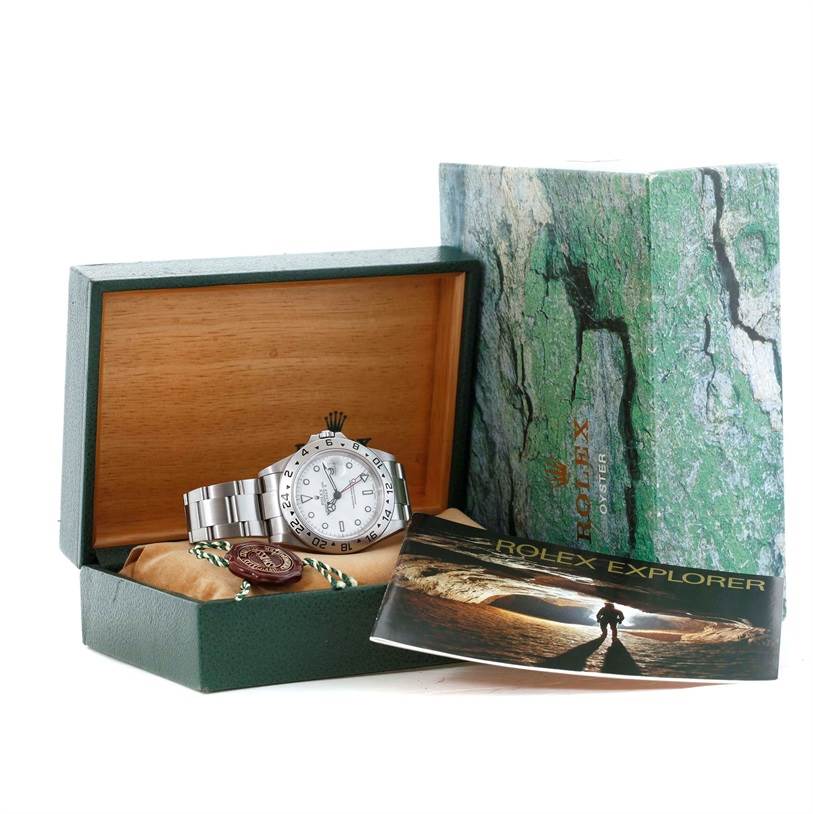 The image shows a Rolex Explorer 16570 Men's Stainless Steel White Dial 16570 Men's Stainless Steel White Dial watch in its box with a booklet and additional accessories.