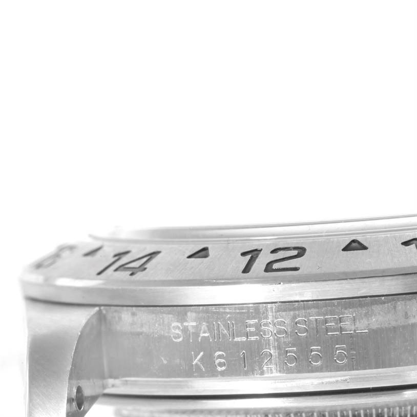 The image shows a close-up of the bezel and part of the case with serial number engraving of a Rolex Explorer 16570 Men's Stainless Steel White Dial 16570 Men's Stainless Steel White Dial watch.