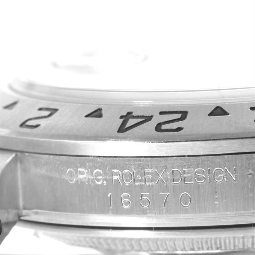 This image shows a close-up of the bezel and side engraving of a Rolex Explorer 16570 Men's Stainless Steel White Dial 16570 Men's Stainless Steel White Dial model, featuring the numbers and model number 16570.
