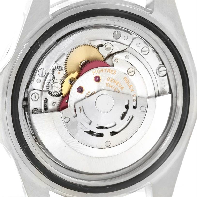 This image shows the internal mechanism of a Rolex Explorer 16570 Men's Stainless Steel White Dial 16570 Men's Stainless Steel White Dial watch from a rear angle, highlighting its gears and rotor.