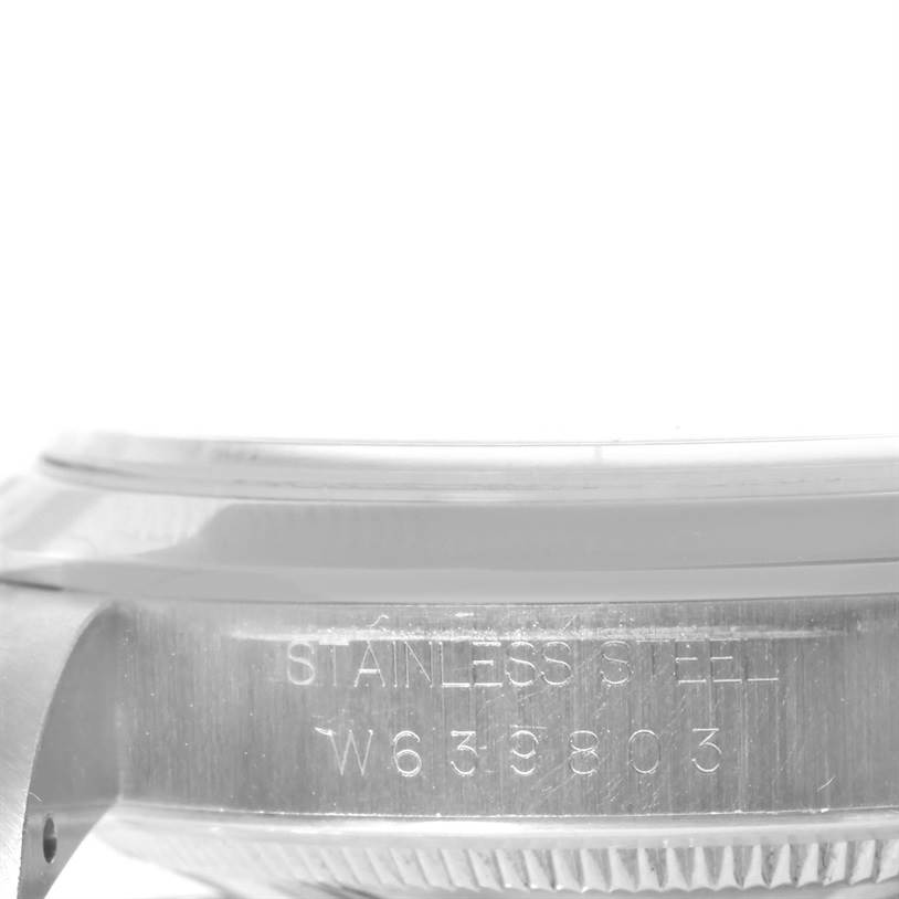 The image shows a side view of a Rolex Explorer 14270 Men's Stainless Steel Black Dial 14270 Men's Stainless Steel Black Dial watch, highlighting the stainless steel casing and engraved serial number.