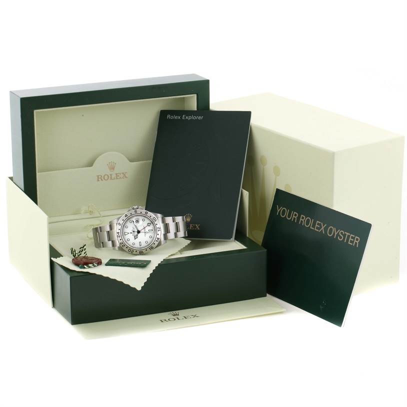 The Rolex Explorer 16570 Men's Stainless Steel White Dial 16570 Men's Stainless Steel White Dial watch is shown at a slight angle along with its box, manuals, and accessories.