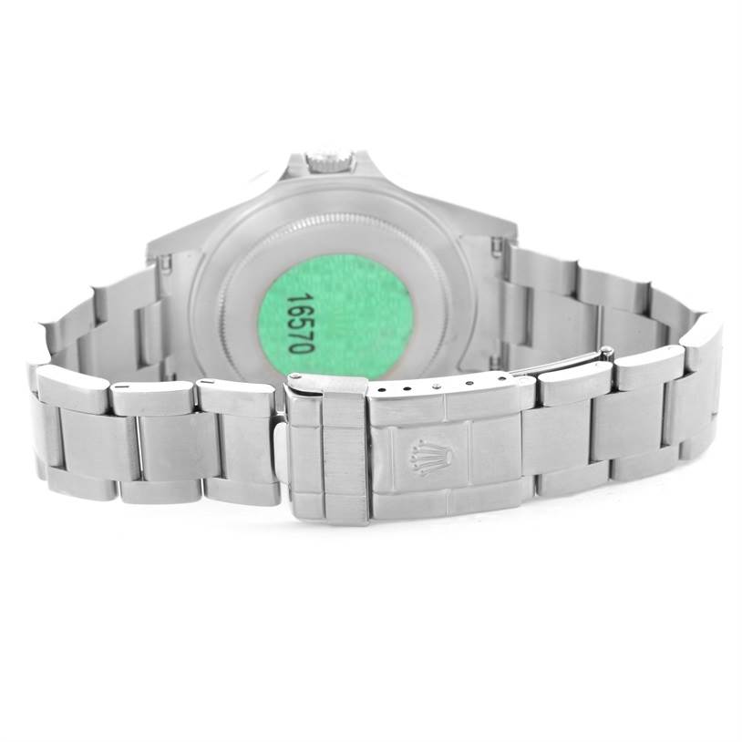 The image shows the back and bracelet clasp of a Rolex Explorer 16570 Men's Stainless Steel White Dial 16570 Men's Stainless Steel White Dial model watch, focusing on the green sticker and model number 16570.