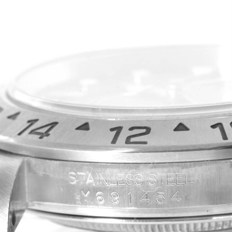 The image shows a close-up of the bezel and part of the side case of a Rolex Explorer 16570 Men's Stainless Steel Black Dial 16570 Men's Stainless Steel Black Dial watch.