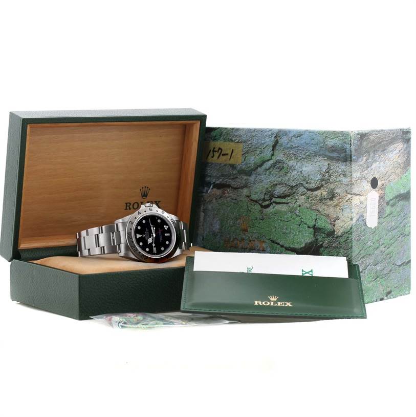 The image shows a Rolex Explorer 16570 Men
s Stainless Steel Black Dial 16570 Men
s Stainless Steel Black Dial watch in its box with associated packaging and documentation.