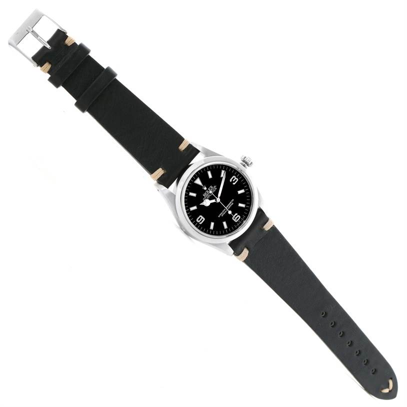 The Rolex Explorer 14270 Men's Stainless Steel Black Dial 14270 Men's Stainless Steel Black Dial watch is shown from a top-down angle, featuring its black leather strap and black dial.