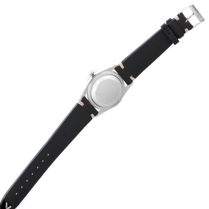 The image shows the back side of a Rolex Explorer 14270 Men's Stainless Steel Black Dial 14270 Men's Stainless Steel Black Dial model watch with its black leather strap and buckle visible.