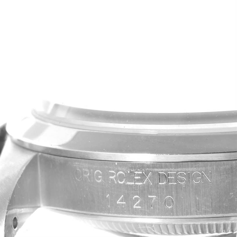 This image shows a close-up of the side of a Rolex Explorer 14270 Men's Stainless Steel Black Dial 14270 Men's Stainless Steel Black Dial watch case, featuring the engraving "ORIG ROLEX DESIGN 14270."