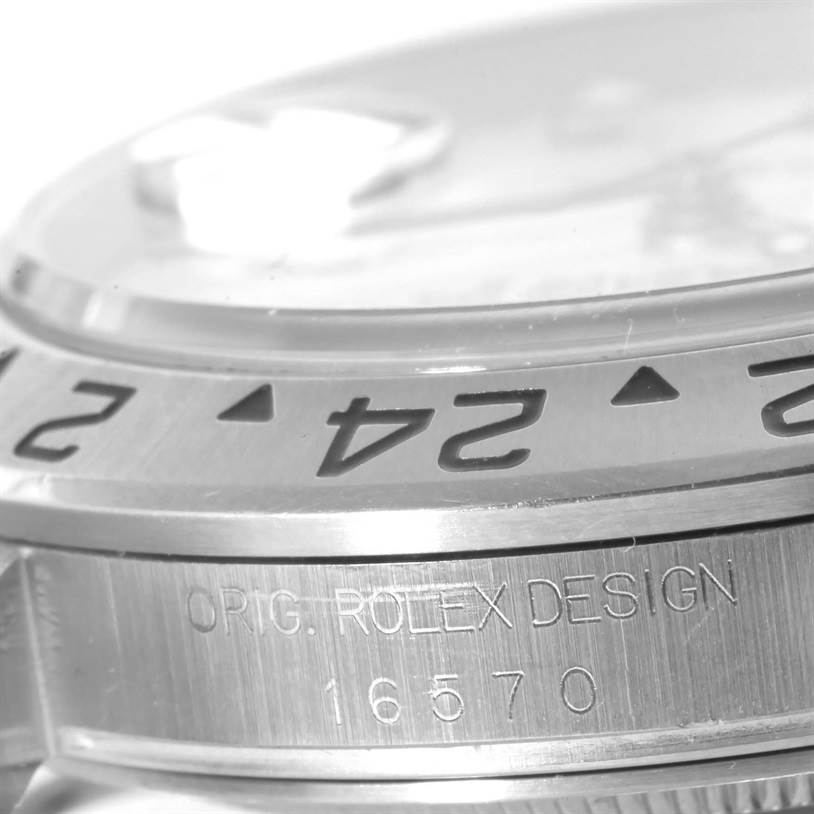 The image shows a close-up angle of the bezel and engraved text on the side of a Rolex Explorer 16570 Men's Stainless Steel Silver Dial 16570 Men's Stainless Steel Silver Dial model watch.