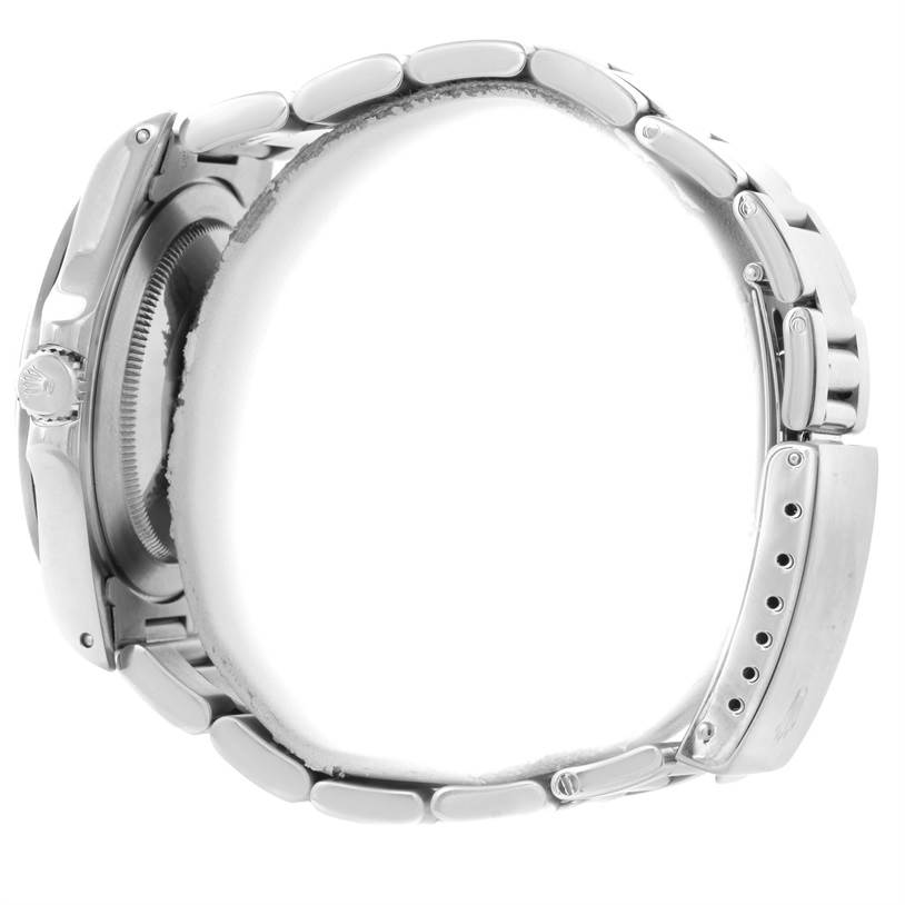 The image shows a side view of a Rolex Explorer 16570 Men's Stainless Steel Silver Dial 16570 Men's Stainless Steel Silver Dial model, featuring its clasp, bracelet, and part of the case.