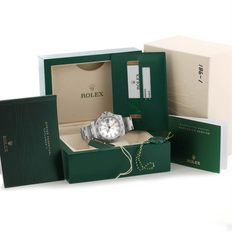 The Rolex Explorer 216570 Men's Stainless Steel White Dial 216570 Men's Stainless Steel White Dial watch is shown at an angle inside its green box, accompanied by manuals and warranty card.