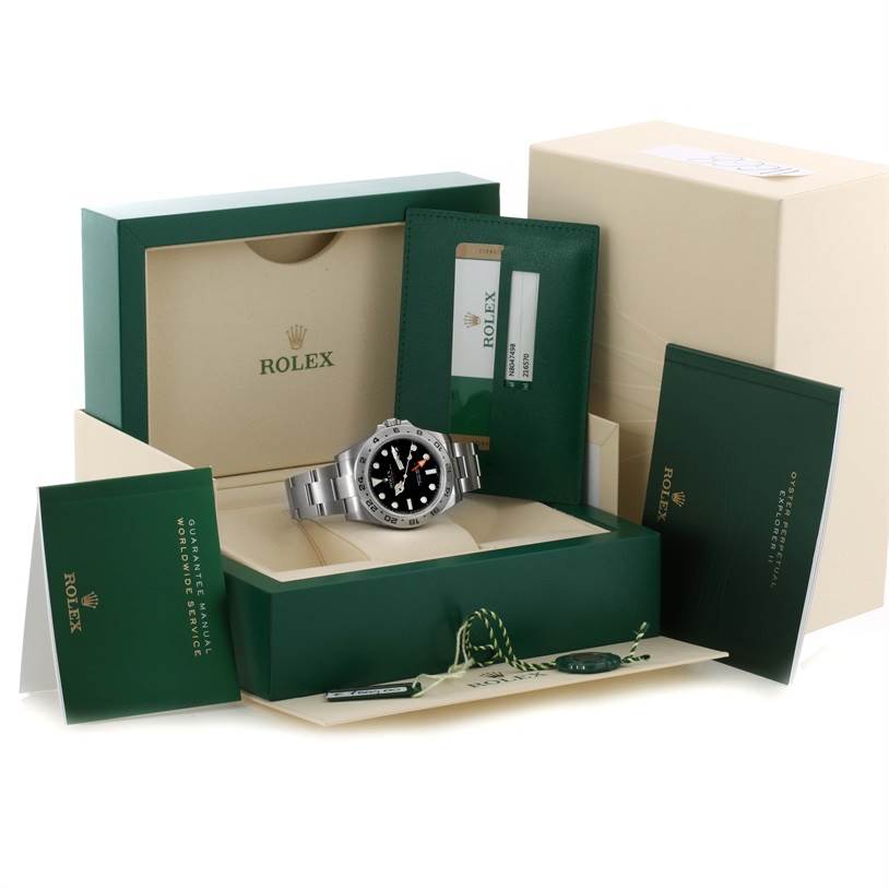 The Rolex Explorer 216570 Men's Stainless Steel Black Dial 216570 Men's Stainless Steel Black Dial watch is shown in its packaging with accessories, including manuals, tags, and warranty card.