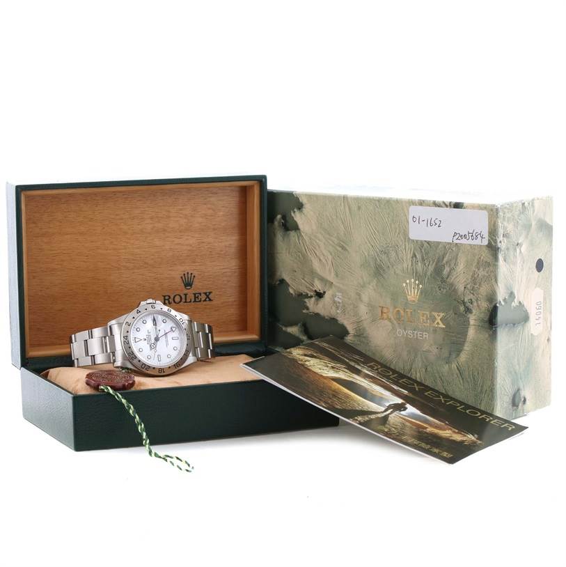 The image shows a Rolex Explorer 16570 Men's Stainless Steel White Dial 16570 Men's Stainless Steel White Dial watch displayed in its open box along with accompanying documents and packaging.