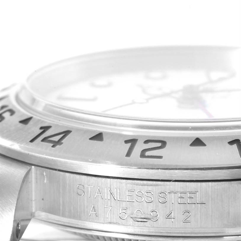 This close-up image of the Rolex Explorer 16570 Men's Stainless Steel White Dial 16570 Men's Stainless Steel White Dial watch shows the bezel, stainless steel case, and serial number engraving.