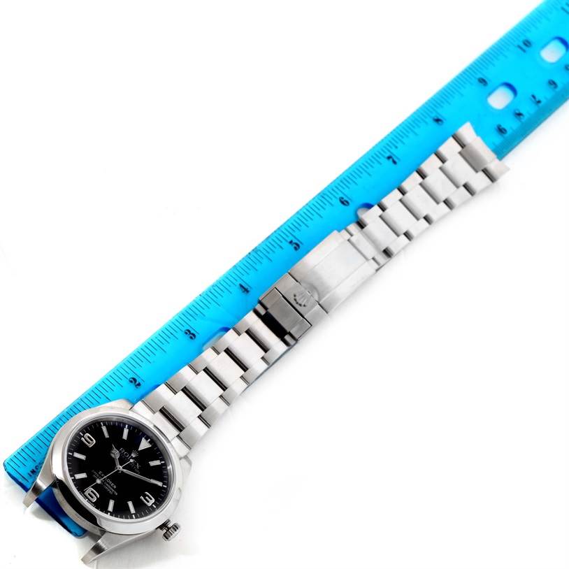 The image shows a Rolex Explorer 214270 Men's Stainless Steel Black Dial 214270 Men's Stainless Steel Black Dial watch laid flat, with a ruler measuring its full length including the bracelet.