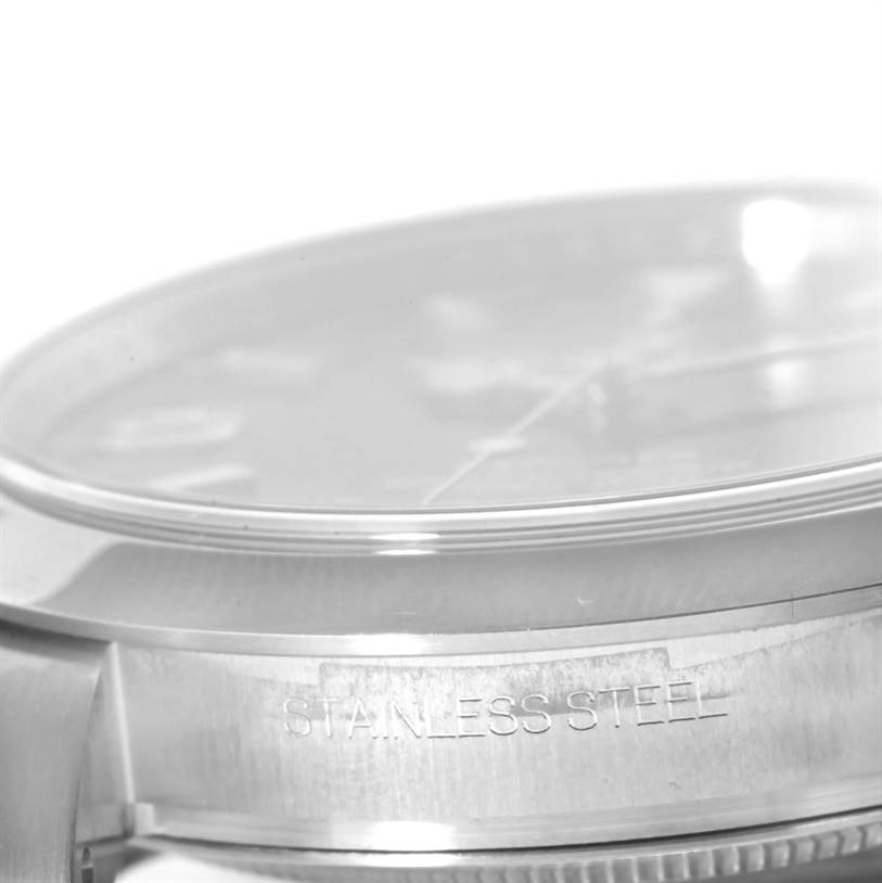 This image shows a close-up side view of a Rolex Explorer 214270 Men's Stainless Steel Black Dial 214270 Men's Stainless Steel Black Dial watch, highlighting the stainless steel case and part of the crystal.