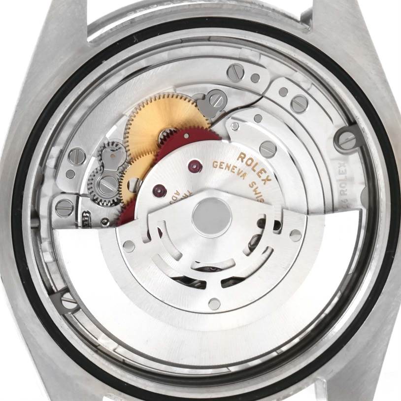 The image shows the internal mechanism of a Rolex Explorer 214270 Men's Stainless Steel Black Dial 214270 Men's Stainless Steel Black Dial watch viewed from the back, revealing gears and the rotor.