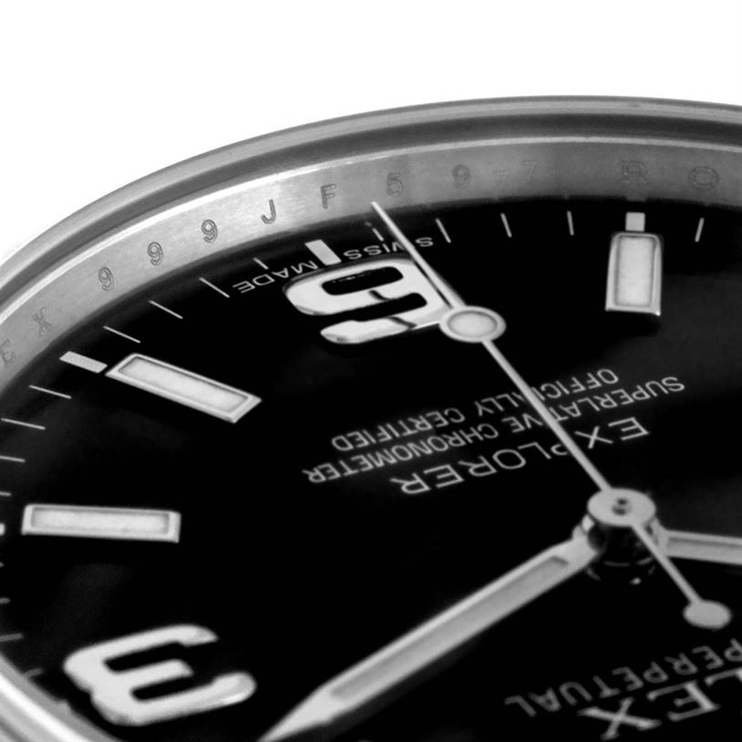The image shows a close-up of the dial and hands of a Rolex Explorer 214270 Men's Stainless Steel Black Dial 214270 Men's Stainless Steel Black Dial watch, highlighting the 9 o'clock position and text details.