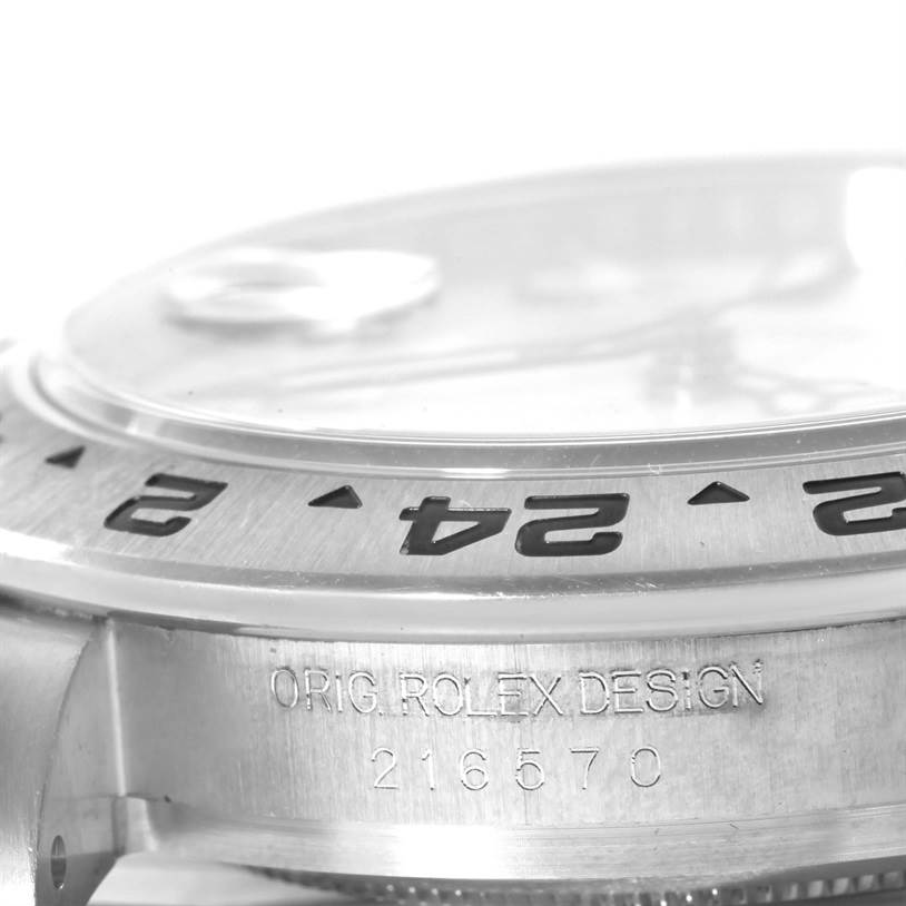 This close-up image shows the side view of the bezel and case for a Rolex Explorer 216570WSO Men's Stainless Steel White Dial 216570WSO Men's Stainless Steel White Dial watch, with the serial number engraved.