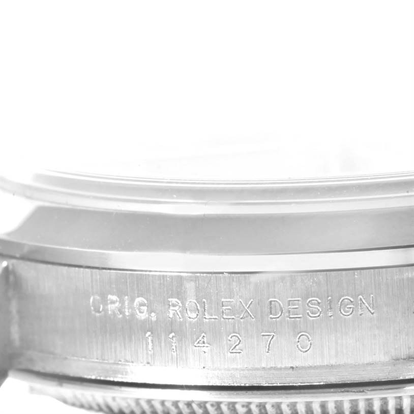 This image shows the side view of a Rolex Explorer 114270 Men's Stainless Steel Black Dial 114270 Men's Stainless Steel Black Dial watch, displaying the engraved model number and "ORIG. ROLEX DESIGN."