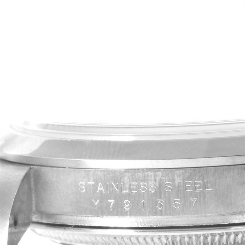 The image shows a close-up angle of the side of a Rolex Explorer 114270 Men's Stainless Steel Black Dial 114270 Men's Stainless Steel Black Dial watch, focusing on the stainless steel casing and serial number.