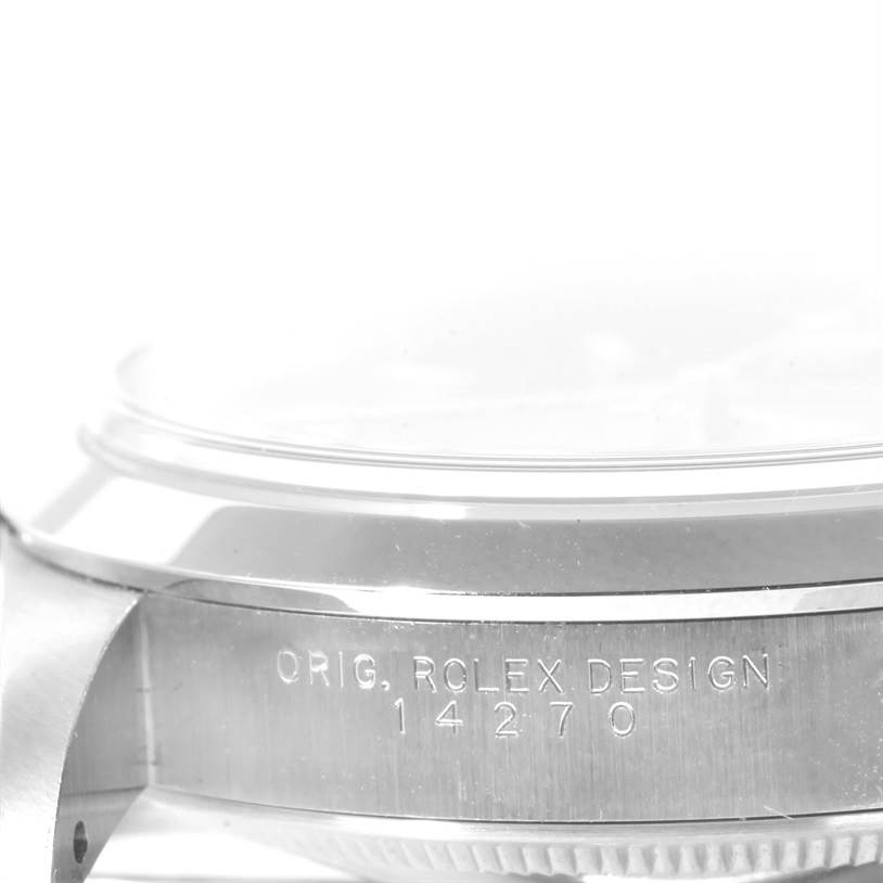 The image shows a side view of the casing of a Rolex Explorer 114270 Men's Stainless Steel Black Dial 114270 Men's Stainless Steel Black Dial watch, featuring its model number and design engraving.