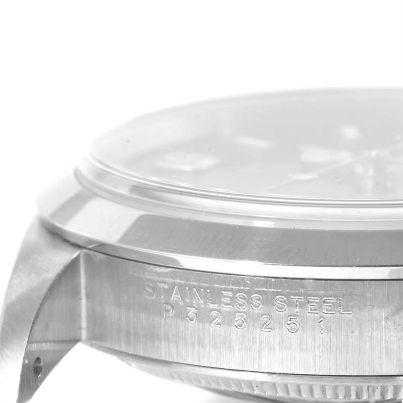 This image shows a partial side view of a Rolex Explorer 114270 Men's Stainless Steel Black Dial 114270 Men's Stainless Steel Black Dial watch, highlighting the stainless steel case and serial number.