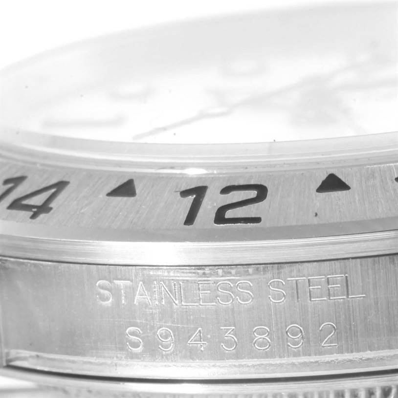 The image shows a close-up of the bezel and case side with serial engraving of a Rolex Explorer 16570 Men's Stainless Steel White Dial 16570 Men's Stainless Steel White Dial model watch.